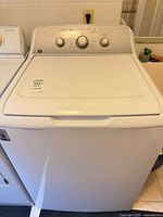 Front view of GE top-load washer showing full exterior