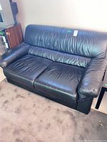 Front full view of black leather loveseat