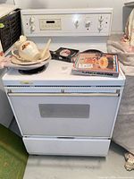Front view of white Gibson electric coil range showing oven door, coil burners and control backsplash