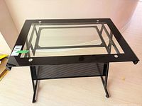 Top view showing clear glass inset, black metal border, fasteners
