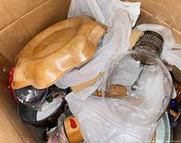 Mixed items in carton including wooden platter, glass pitcher, wooden bottle and goblets