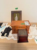 Overall lot showing jewelry chest, ring box, gloves, wall plaque