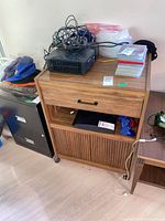 Front view of entire cabinet showing drawer, open shelf, tambour doors and casters