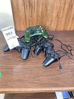 Four controllers displayed on wooden surface