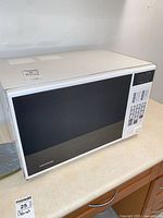 Front view of white Magnasonic microwave on countertop
