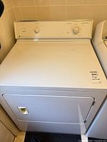 Front view of Maytag LDE8404ADE dryer showing door and overall cabinet