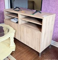 Front view showing open shelves, cabinet doors, metal legs