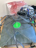 Top view of Xbox console with controllers and cables on top
