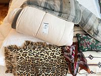 Overall lot showing comforter, throw blankets, pillows and scarf