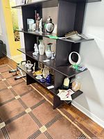 Full view of assembled dark brown laminate bookshelf with contents on shelves