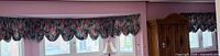 Full room view showing multiple balloon valance sections installed over bay window
