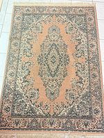 Full view of entire rug showing overall pattern, colors and fringe