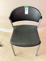 Front view of black plastic side chair with gray metal legs