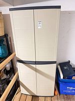 Front view of beige plastic resin storage cabinet, doors closed
