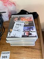 Stack of PS3 game cases showing 007 Legends on top