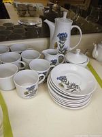 Full grouping of porcelain pieces on counter