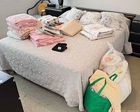 Full view of queen bed with headboard, mattress, linens on top