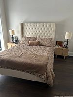 Assembled queen bed showing upholstered headboard and frame