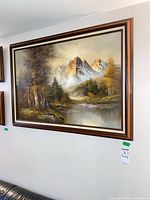 Full view of framed landscape painting on wall