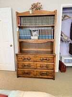 Front view showing open shelving and six-drawer base