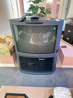 Front view of Sony Trinitron XBR CRT TV on stand, remote, VCR visible