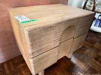 Front view of light wood Structube nightstand showing two drawers and arched front detail