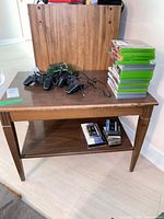 Full view of rectangular walnut veneer side table with items on top (not included)