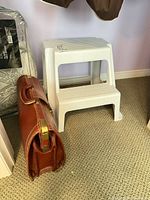 Stool and briefcase side view showing overall form and condition