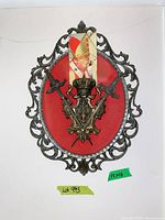 Front view of oval metal-framed plaque with red backing, metal crest and crossed swords
