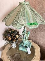 Full view lamp and bouquet on table