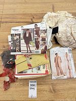 Pile of pattern envelopes including Vogue, McCall’s, Simplicity, tissue pieces and instruction sheets