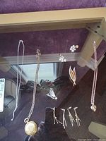 Group shot showing all jewellery pieces laid out on glass surface