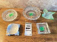 Group shot of five assorted ashtrays displaying size labels