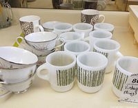 Group of Fire-King mugs, bone china teacups with saucers, porcelain script mugs