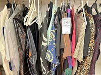 Rack showing assorted tops, jackets and blazers