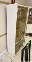 Side view of full cabinet showing off-white finish