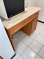 Front view showing cabinet structure, drawers, open alcove and countertop