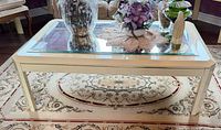 Top view of cream wood coffee table showing mirrored glass surface and trim