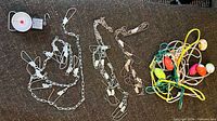 Overview of three metal chain stringers, cord stringer with floats, and hanging scale