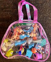 Front view of clear pink-trimmed bag full of small toys