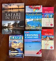 All six travel guidebooks laid out on floor