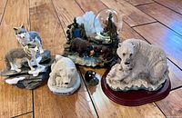 All five wildlife decor items grouped on wood floor