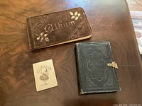 Group shot of autograph album, photo album, miniature calendar