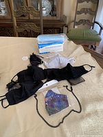 Entire assortment including disposable mask box, various cloth masks, chain strap, pouches