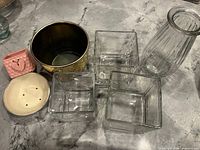 All seven containers and disc on countertop