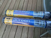 two sealed rolls of Econo black fiberglass screen on deck