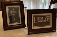 Both framed artworks on table showing overall appearance