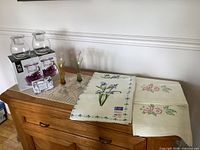 Overall lot showing towels, boxed candle holders, bud vases, soap