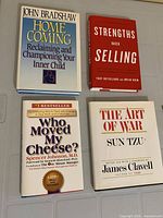 All four hardcover books laid out on surface