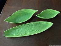 Top view of all three lime chartreuse leaf platters showing sizes and ribbed pattern